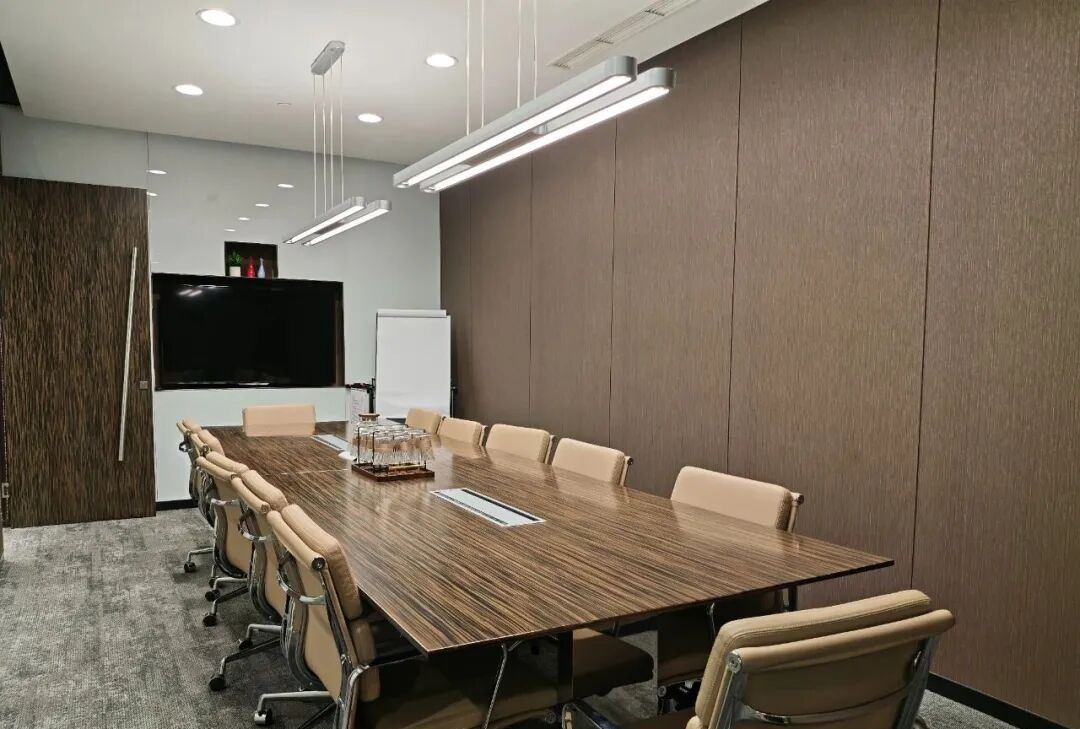 商务会议室实景，长形会议桌与显示屏